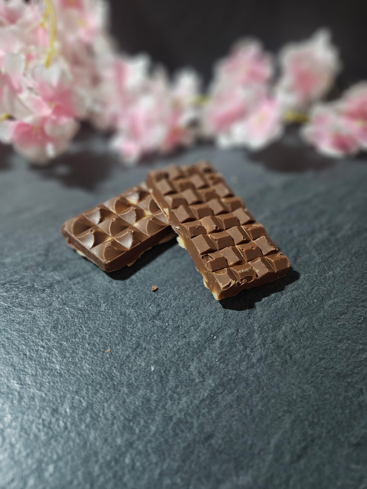 2 milk chocolate topped fudge bars laid in a cross pattern