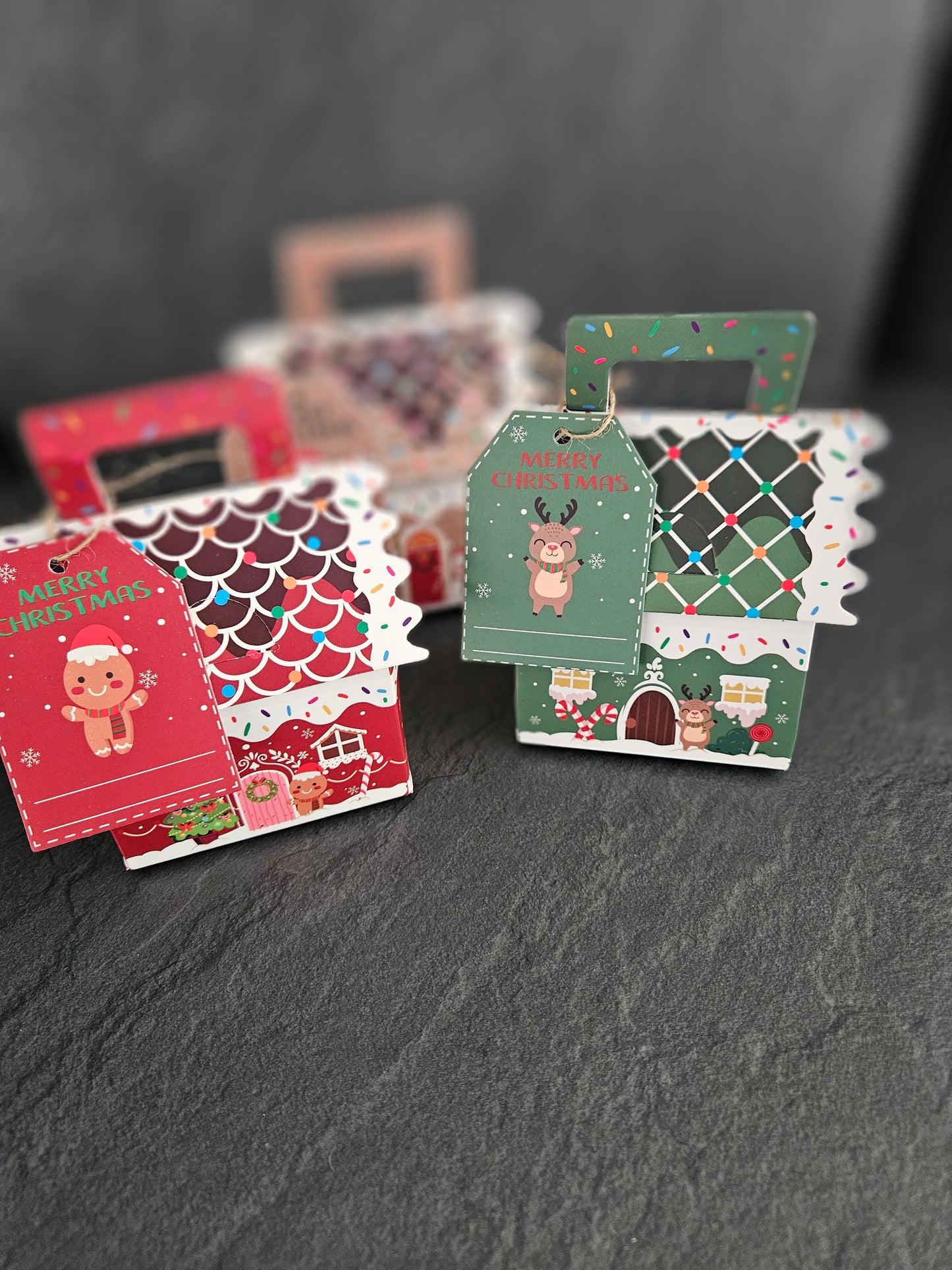 Set of decorative packaging with Christmas designs on a dark surface