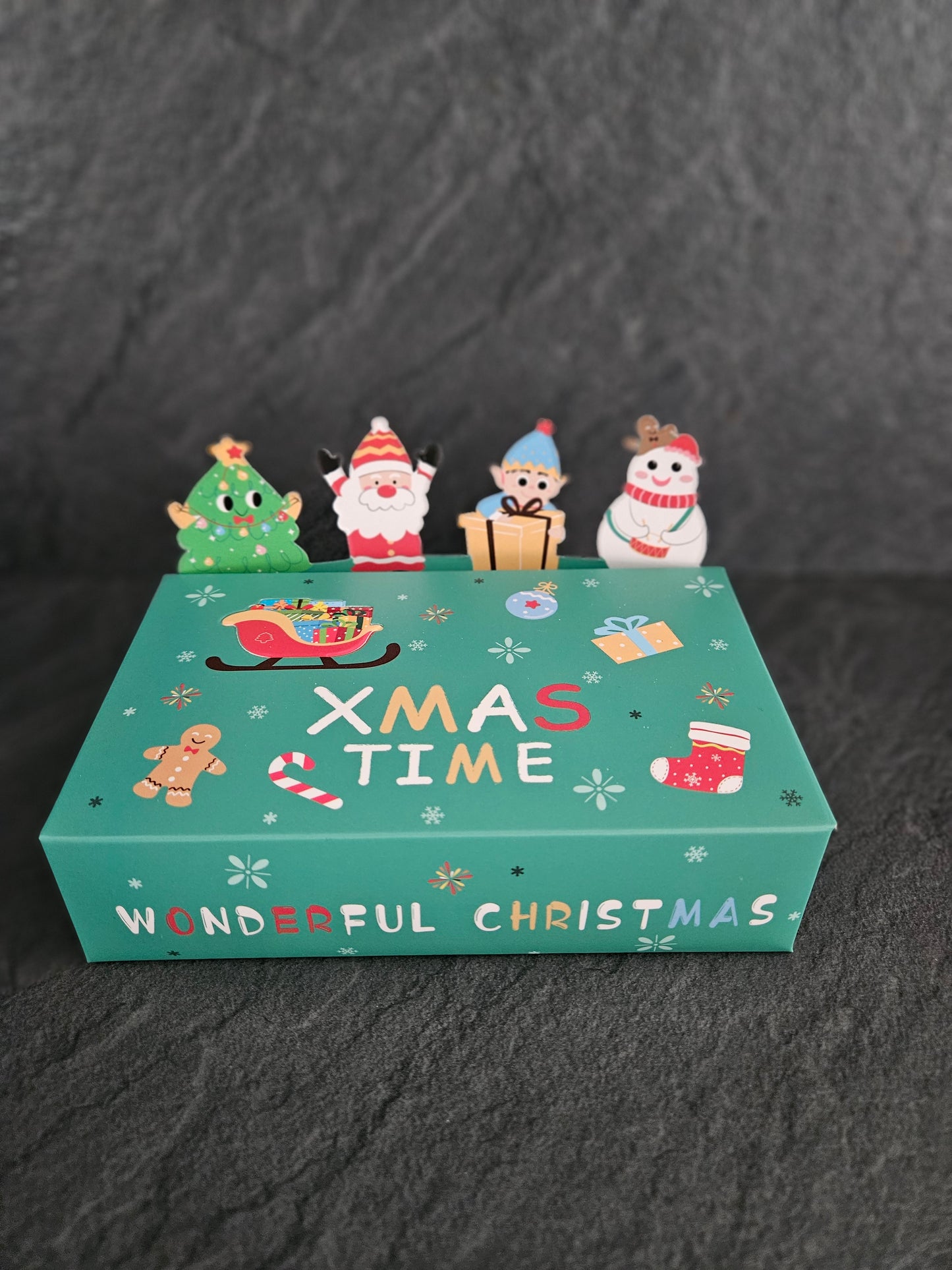 Christmas-themed product packaging with cartoon characters on a dark background