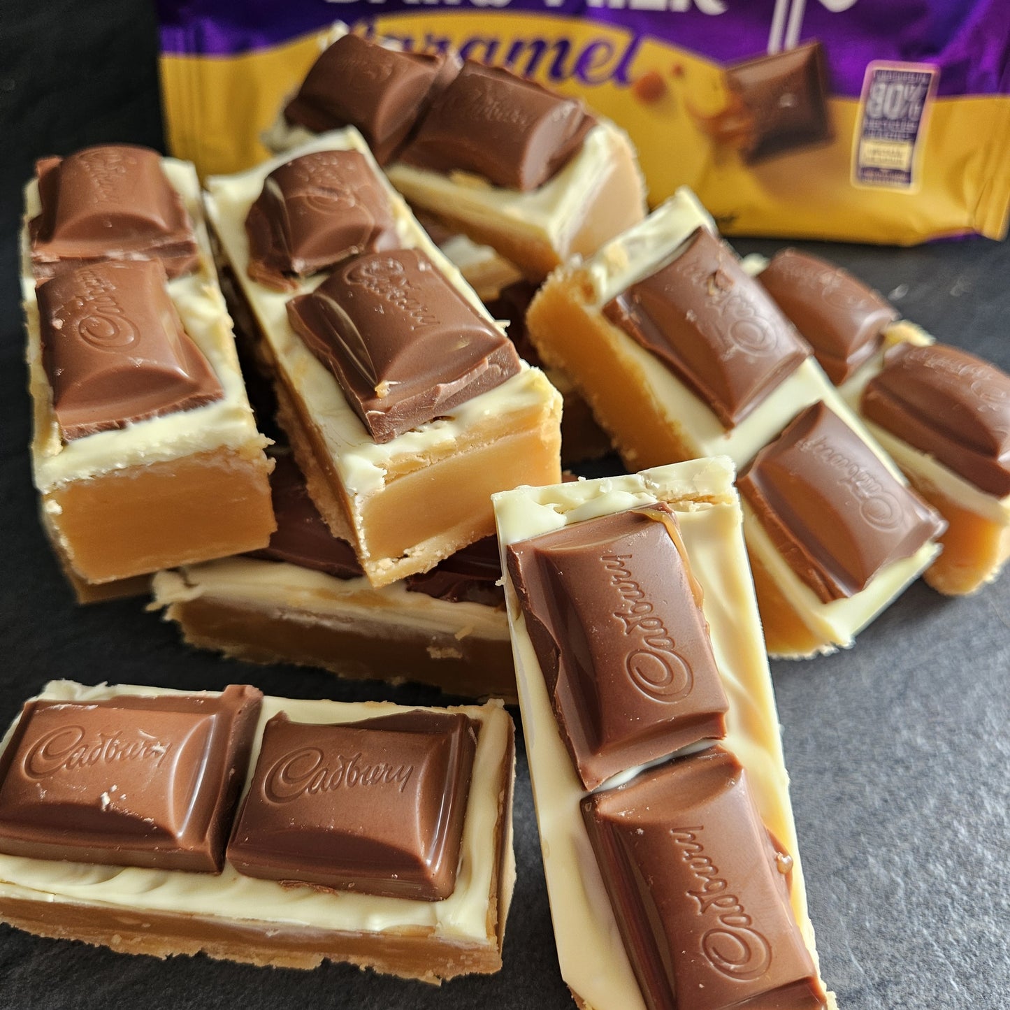 Large fudge bars topped with white chocolate and Cadbury's caramel pieces