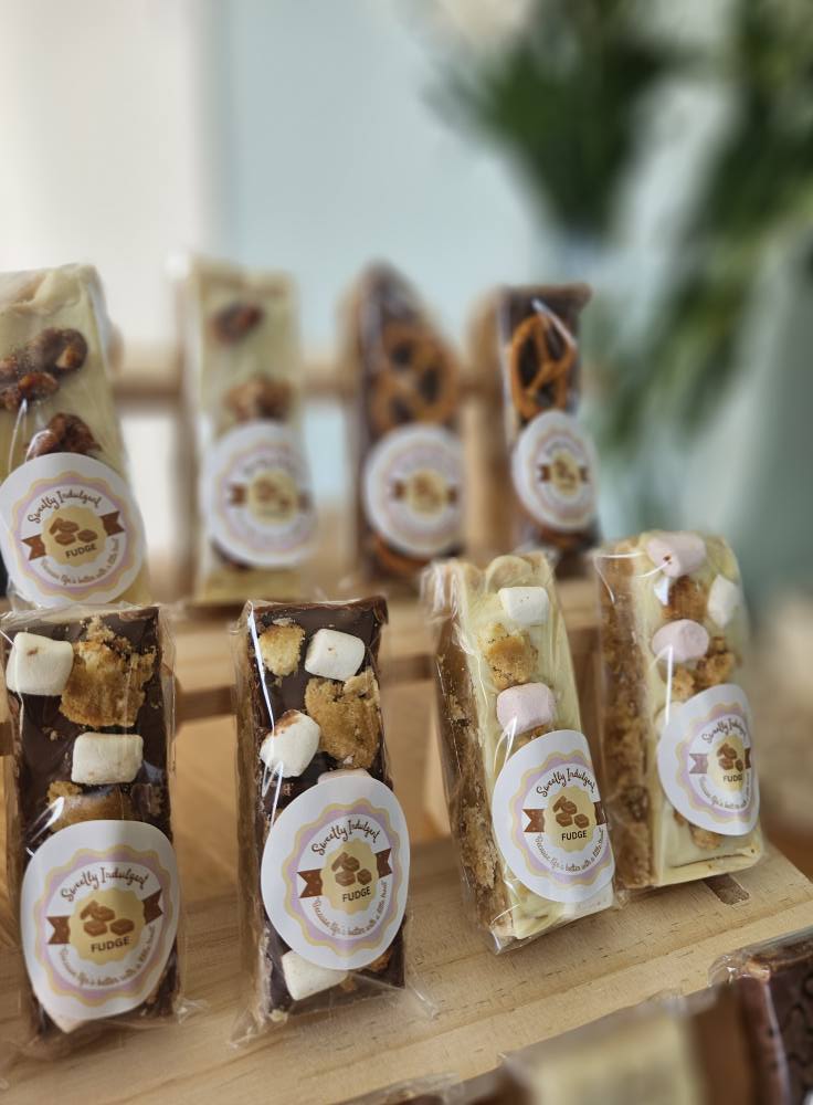 Large Fudge Bars Assorted Toppings Displayed on Wooden Rack