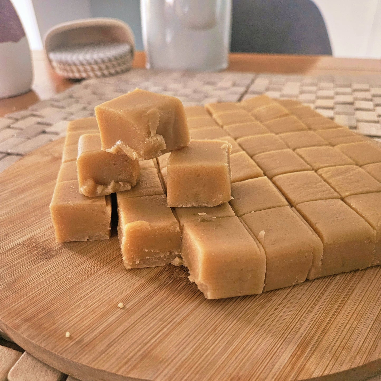 Square pieces of fudge on a wooden cutting board