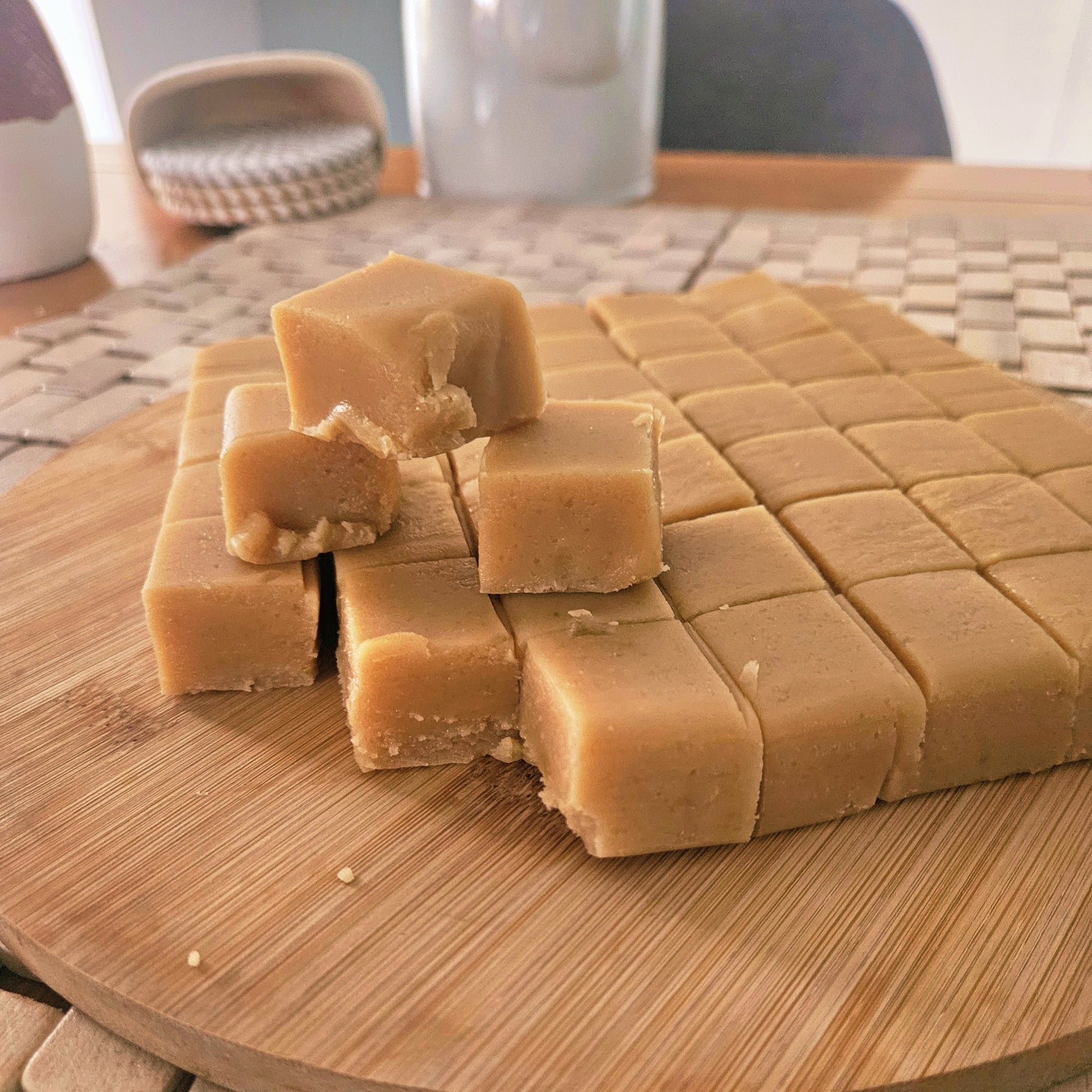 Square pieces of fudge on a wooden cutting board